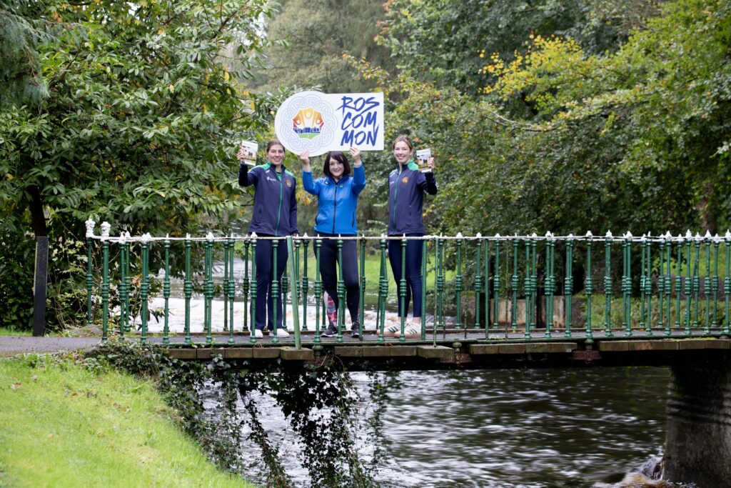 Sisters Aoife and Lisa O'Rourke pictured with Lisa Joy, Roscommon County Council Tourism Officer, all holding a Visit Roscommon sign.